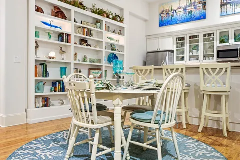 a view of a dining room with furniture and wooden floor