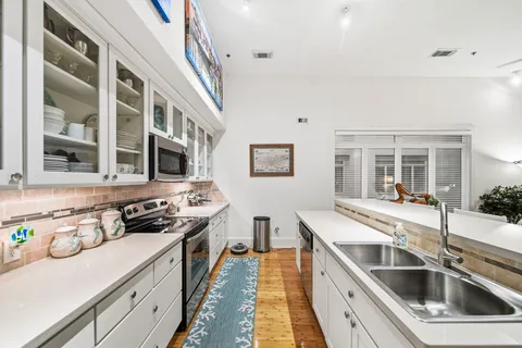 a kitchen with stainless steel appliances a stove a sink and a refrigerator