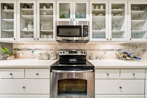 a kitchen with granite countertop a stove and a sink
