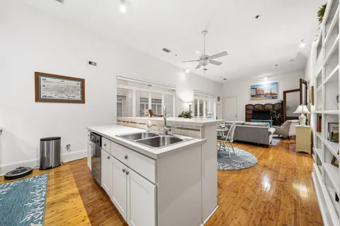 a kitchen with stainless steel appliances granite countertop a sink and a refrigerator