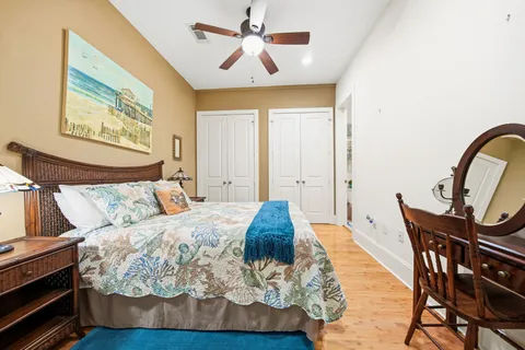 a bedroom with a bed a dresser and chair