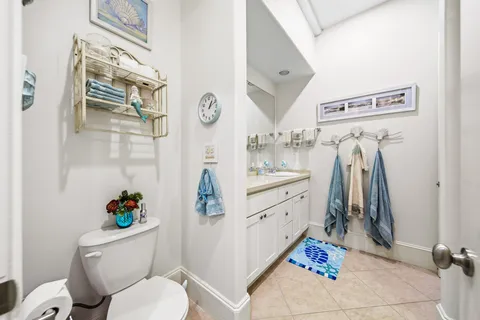 a bathroom with a sink mirror vanity and toilet