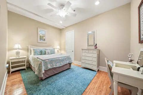 a spacious bedroom with a bed a dresser and a couch