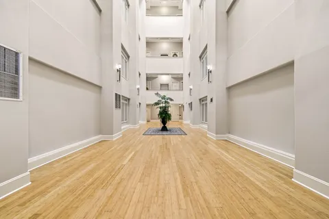 a view of a hallway view with wooden floor and staircase