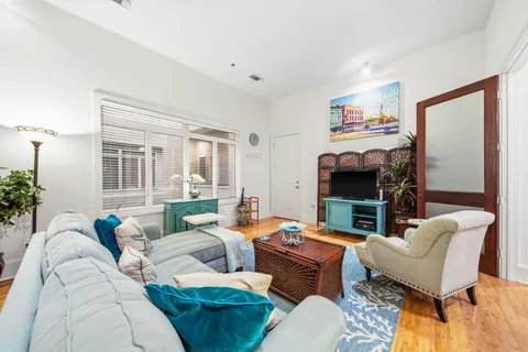a living room with furniture a fireplace and a window