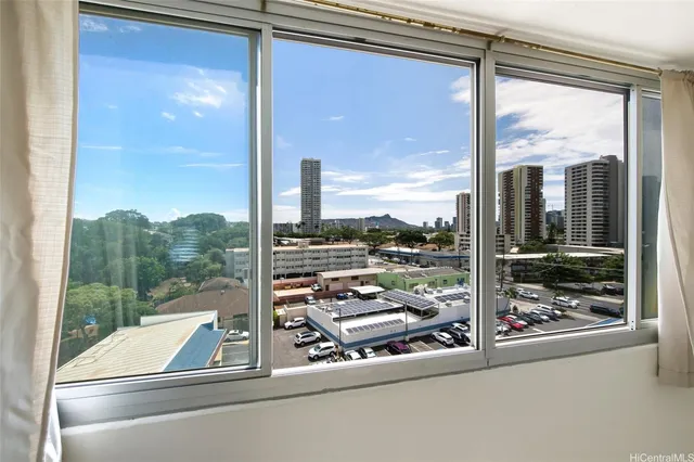 a spacious bedroom with a bed and a potted plant