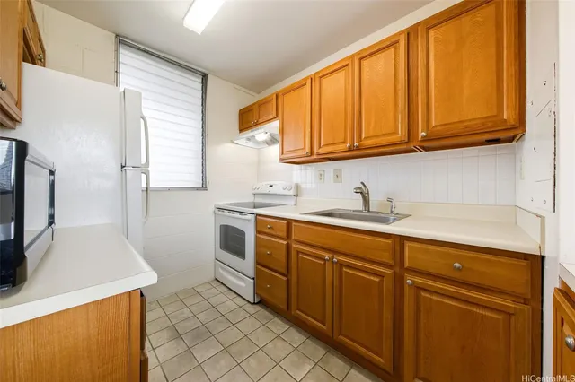 a utility room with cabinets washer and dryer