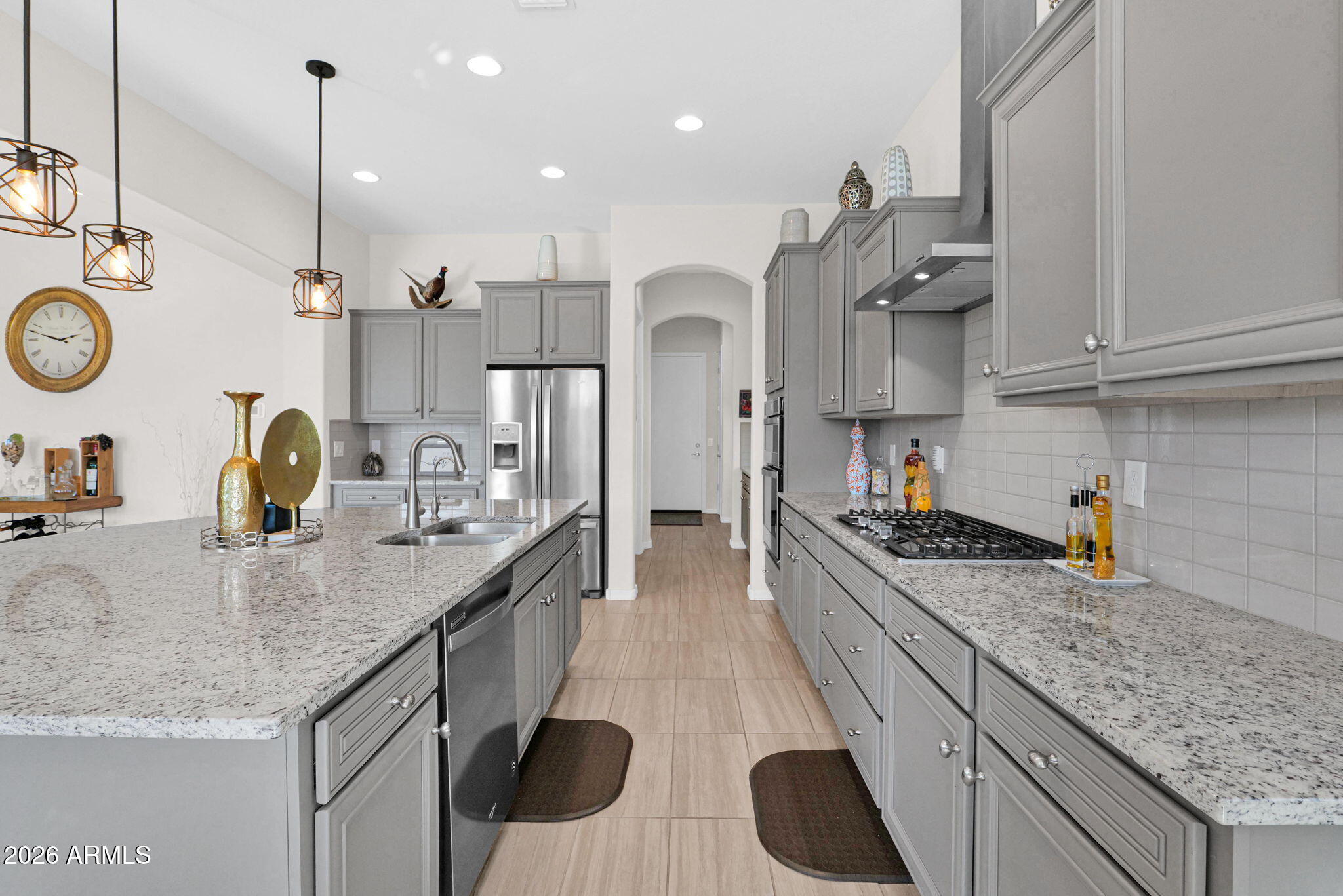 7723 West Willow Way Florence, AZ 85132 - Photo 18 of 64 a kitchen with kitchen island granite countertop a sink a stove and cabinets