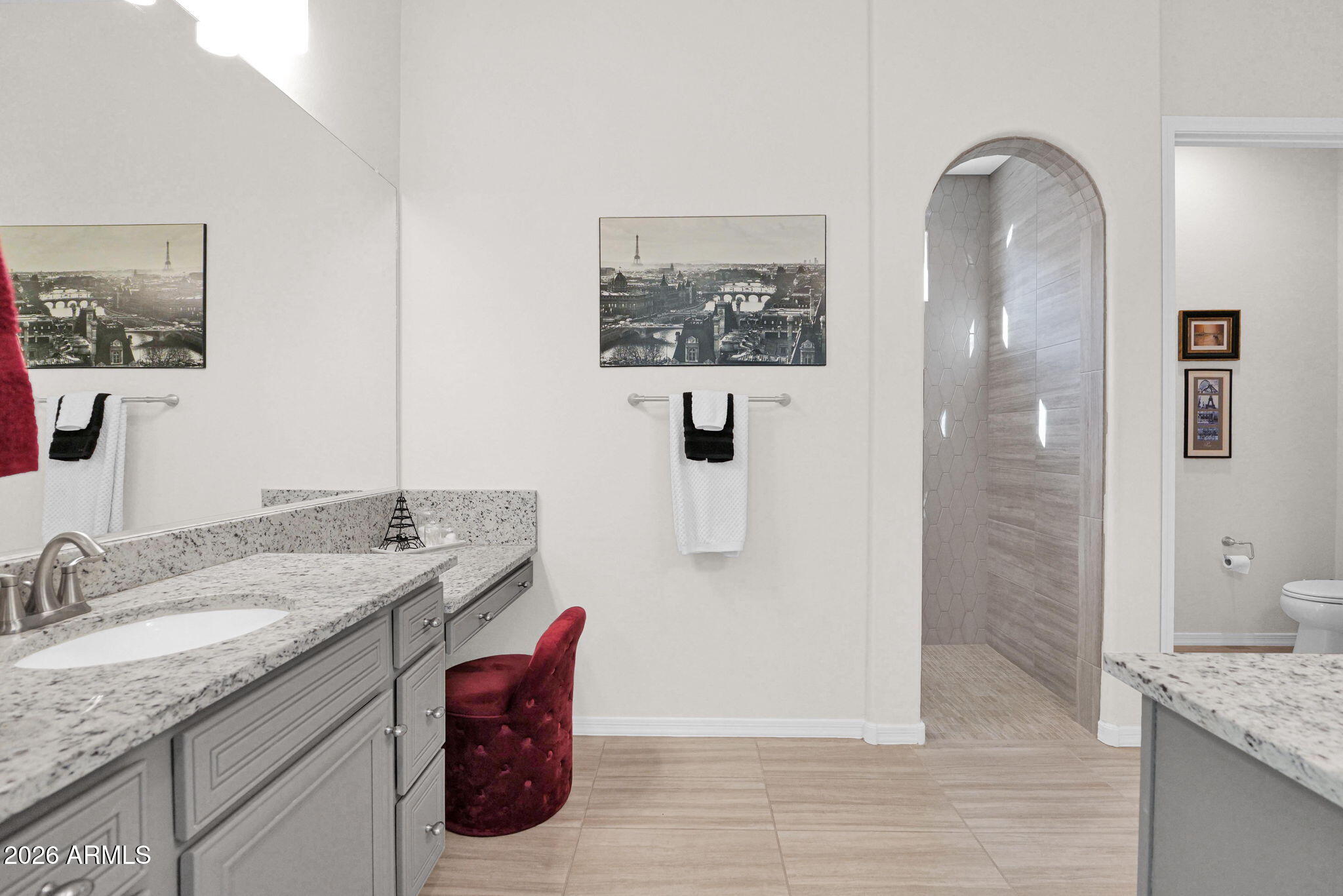 7723 West Willow Way Florence, AZ 85132 - Photo 25 of 64 a bathroom with a granite countertop sink a mirror a shower and vanity