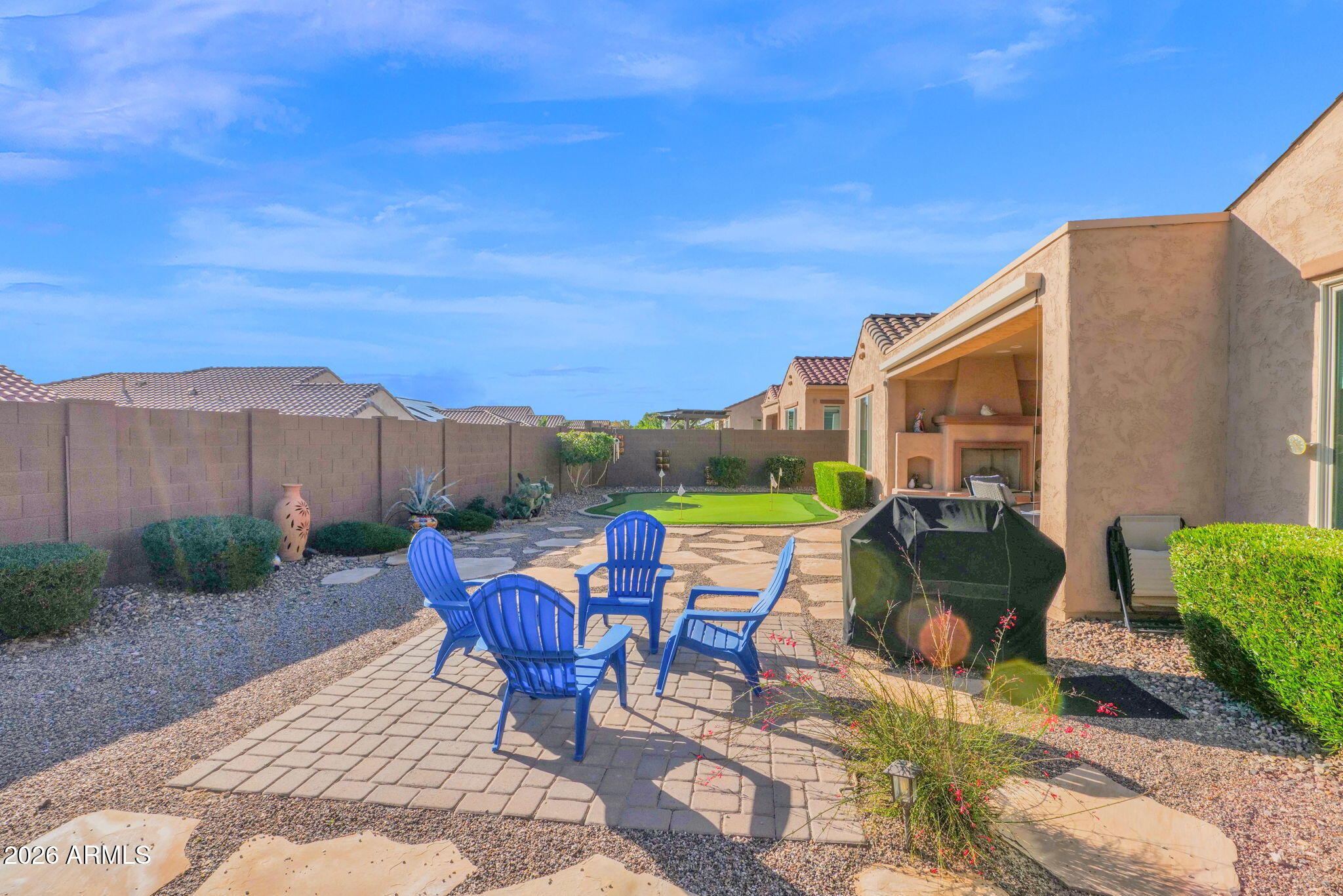 7723 West Willow Way Florence, AZ 85132 - Photo 39 of 64 a view of a patio with table and chairs potted plants with wooden fence