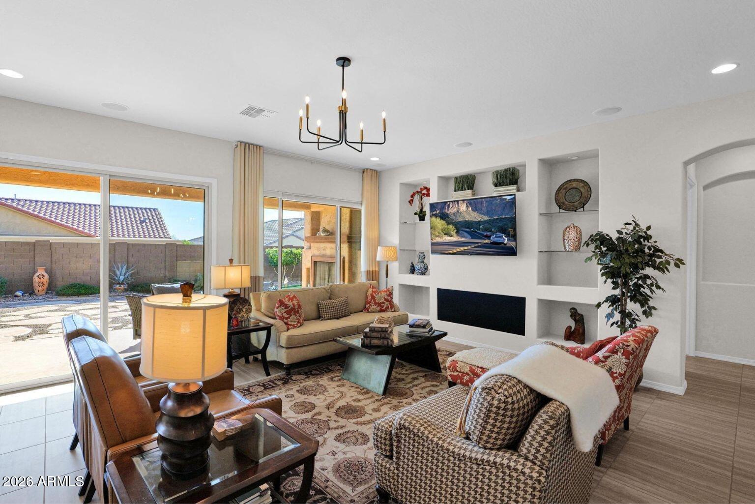 7723 West Willow Way Florence, AZ 85132 - Photo 6 of 64 a living room with furniture fireplace and a large window