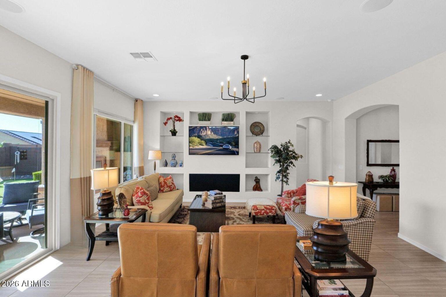 7723 West Willow Way Florence, AZ 85132 - Photo 7 of 64 a living room with furniture and a fireplace