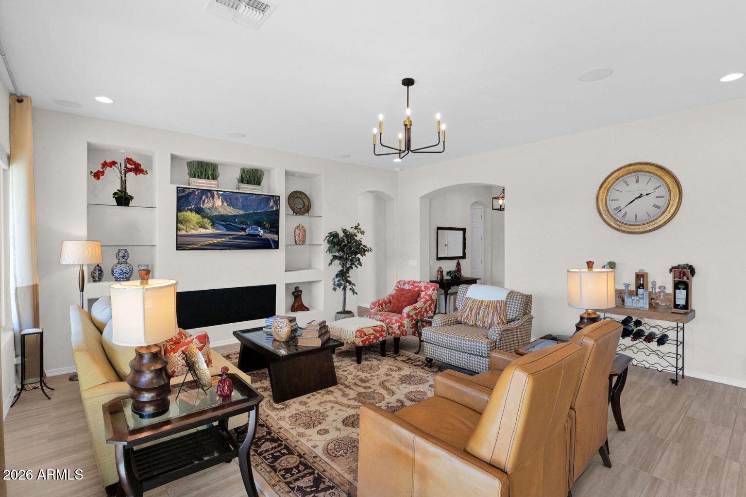 7723 West Willow Way Florence, AZ 85132 - Photo 8 of 64 a living room with furniture a flat screen tv and a fireplace