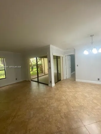 an empty room with windows and entrance