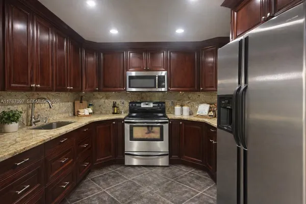 a kitchen with a sink stainless steel appliances and cabinets