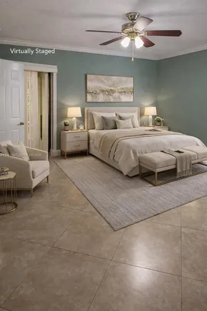 a bedroom with a large bed and a chandelier