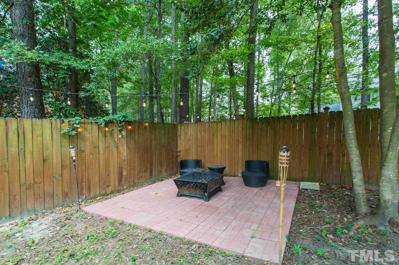 3533 Tunas Street Raleigh, NC 27616 - Photo 11 of 30 a backyard of a house with chairs and a yard