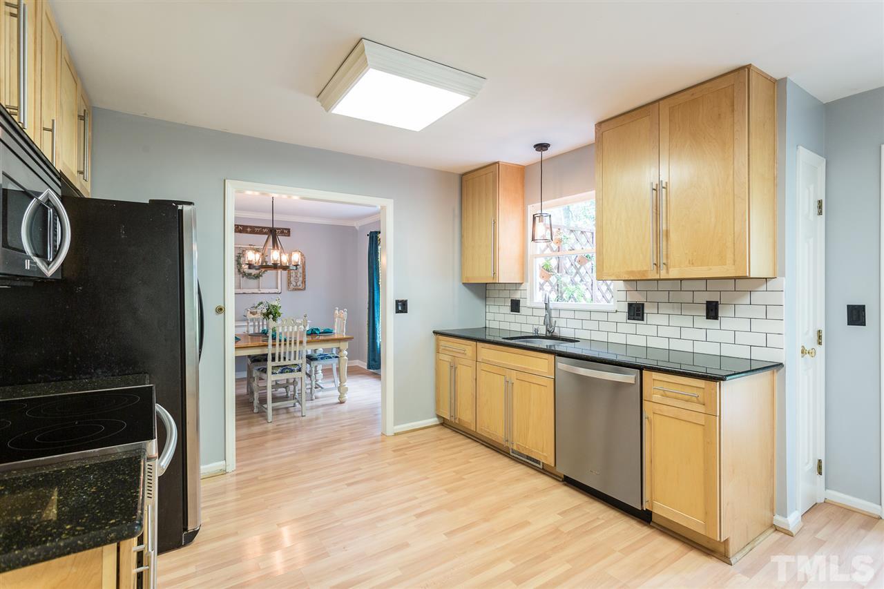 3533 Tunas Street Raleigh, NC 27616 - Photo 20 of 30 a kitchen with stainless steel appliances granite countertop a stove a sink and a microwave