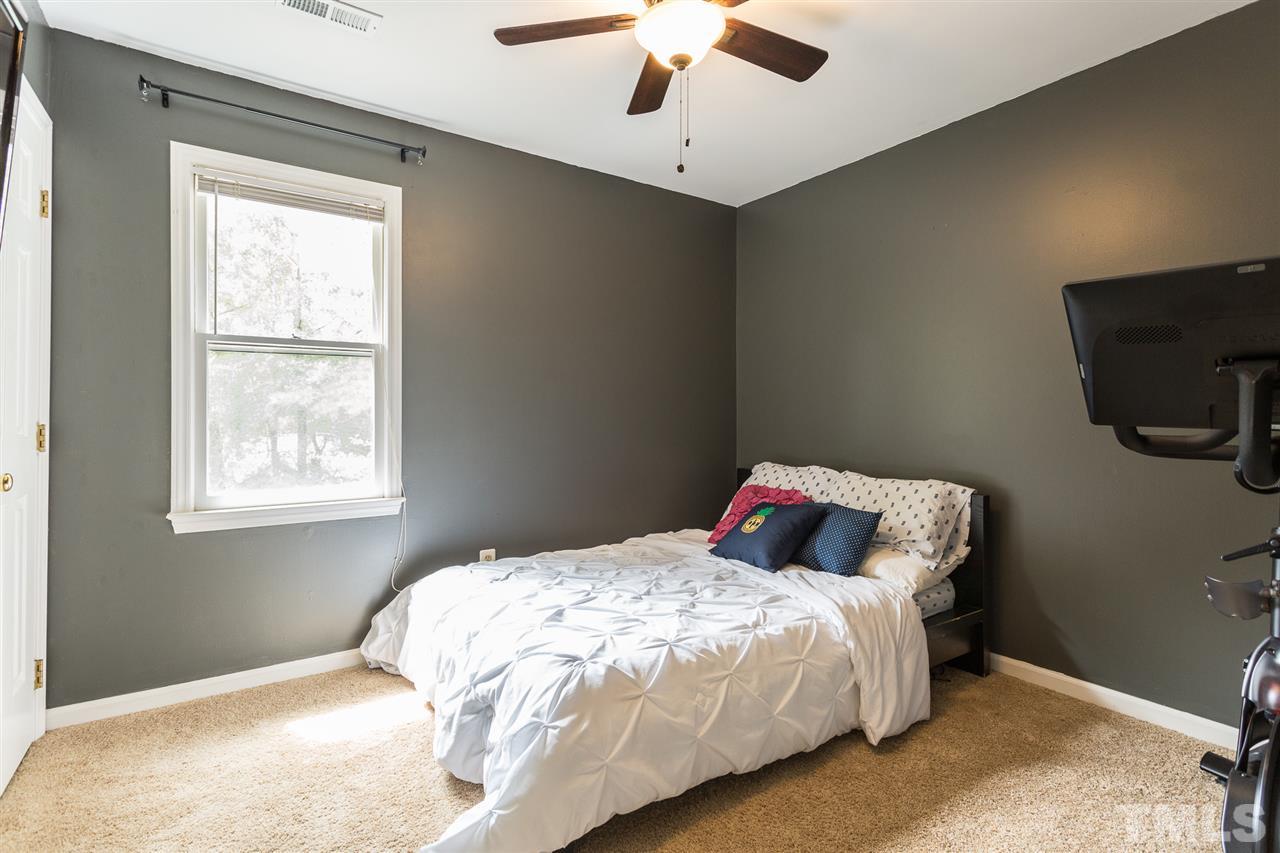 3533 Tunas Street Raleigh, NC 27616 - Photo 25 of 30 a bedroom with a bed and a flat tv screen