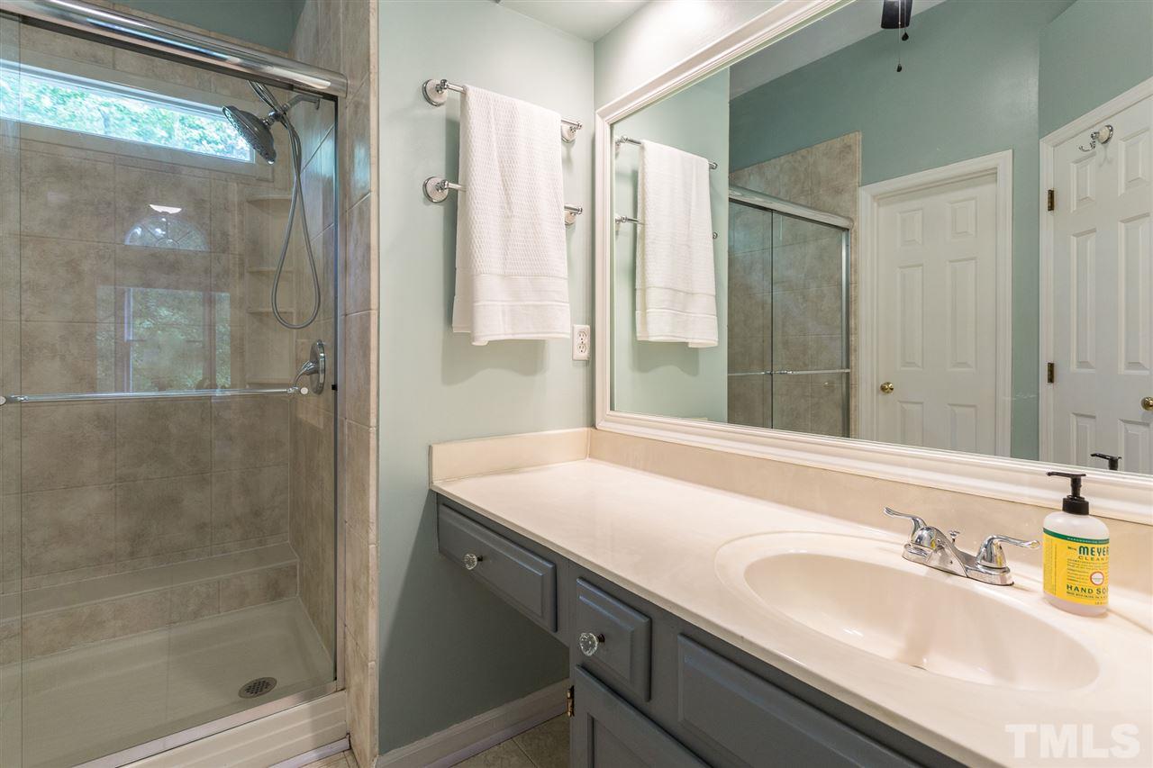 3533 Tunas Street Raleigh, NC 27616 - Photo 28 of 30 a bathroom with a granite countertop sink a mirror and shower