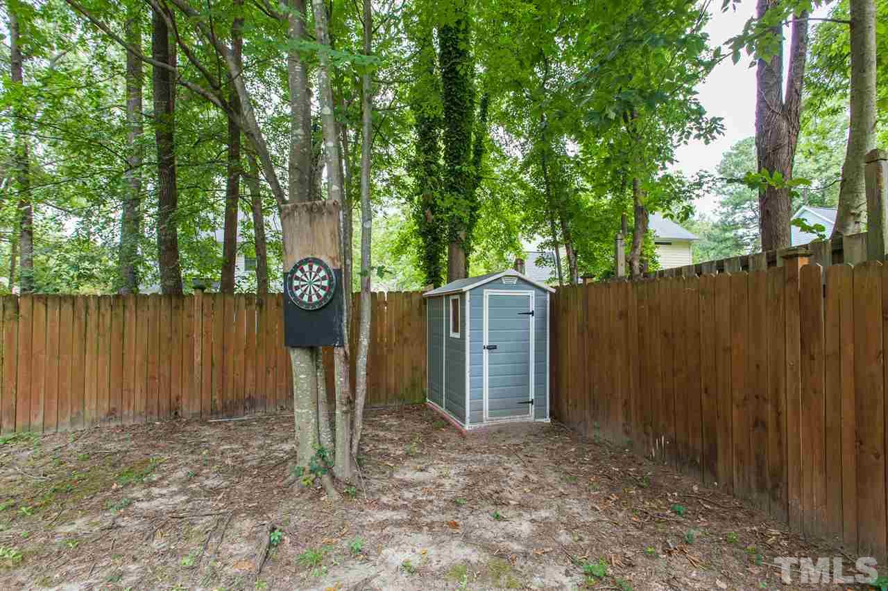 3533 Tunas Street Raleigh, NC 27616 - Photo 10 of 30 a view of a backyard with large trees and wooden fence