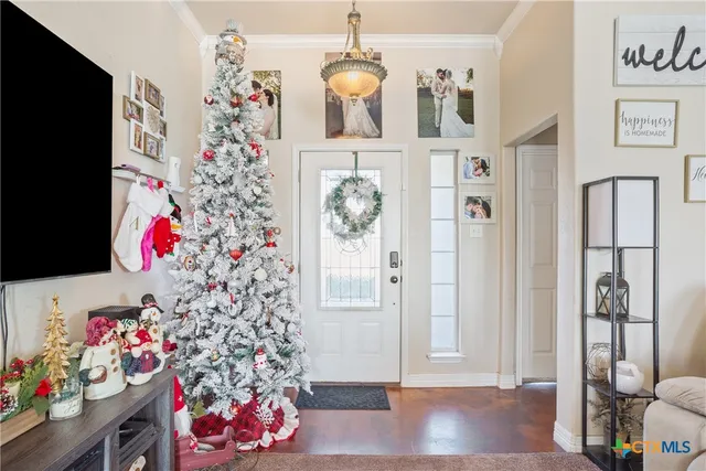 a living room with furniture and a chandelier