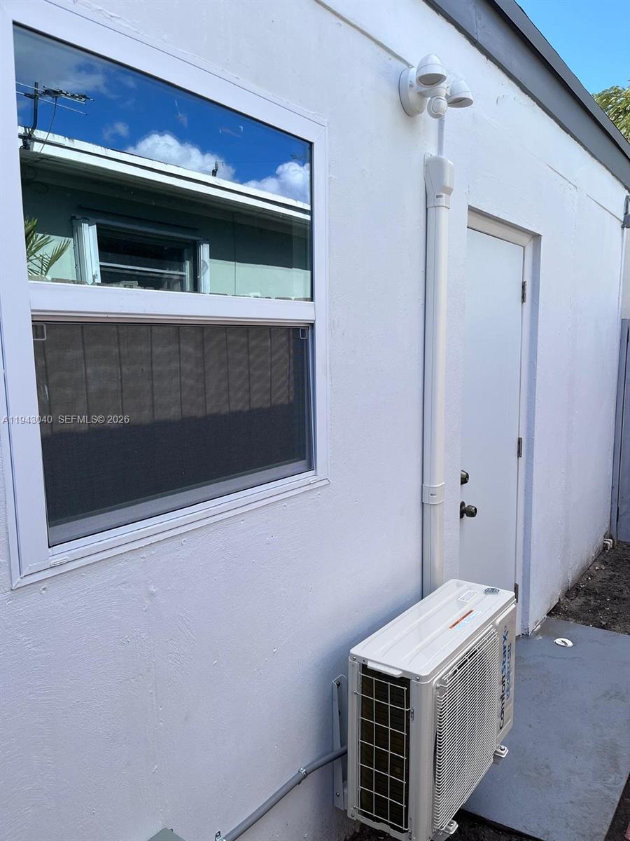 50 Northwest 68th Court, Unit 3 Miami, FL 33126 - Photo 2 of 9 a kitchen with a sink and a microwave