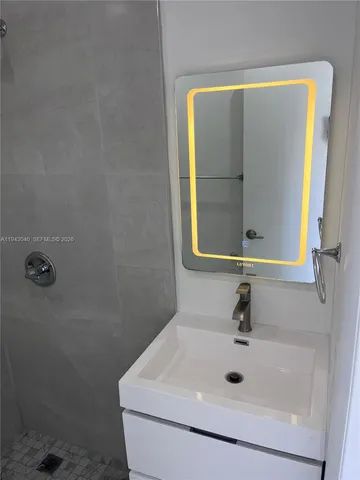 a bathroom with a sink and mirror