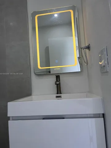 a bathroom with a sink and a mirror