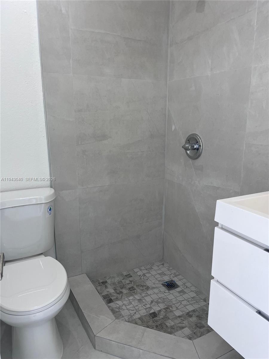 50 Northwest 68th Court, Unit 3 Miami, FL 33126 - Photo 8 of 9 a bathroom with a toilet and a shower