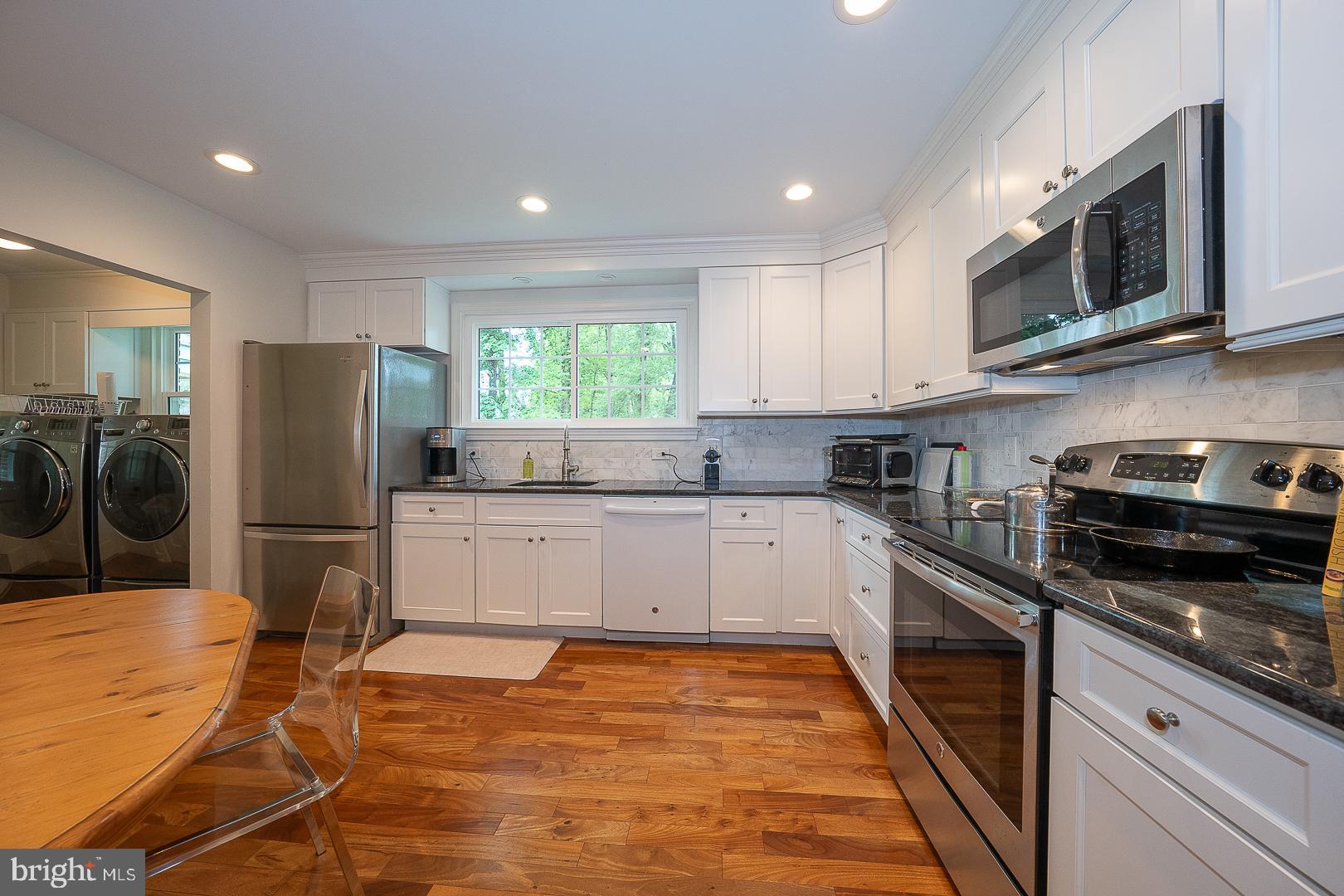 538 Conestoga Road Villanova, PA 19085 - Photo 10 of 39 a kitchen with stainless steel appliances granite countertop a refrigerator stove microwave and sink