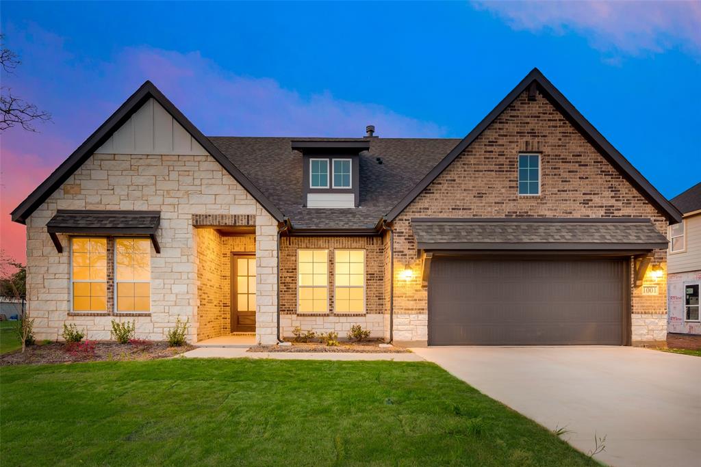 a front view of a house with a yard and garage