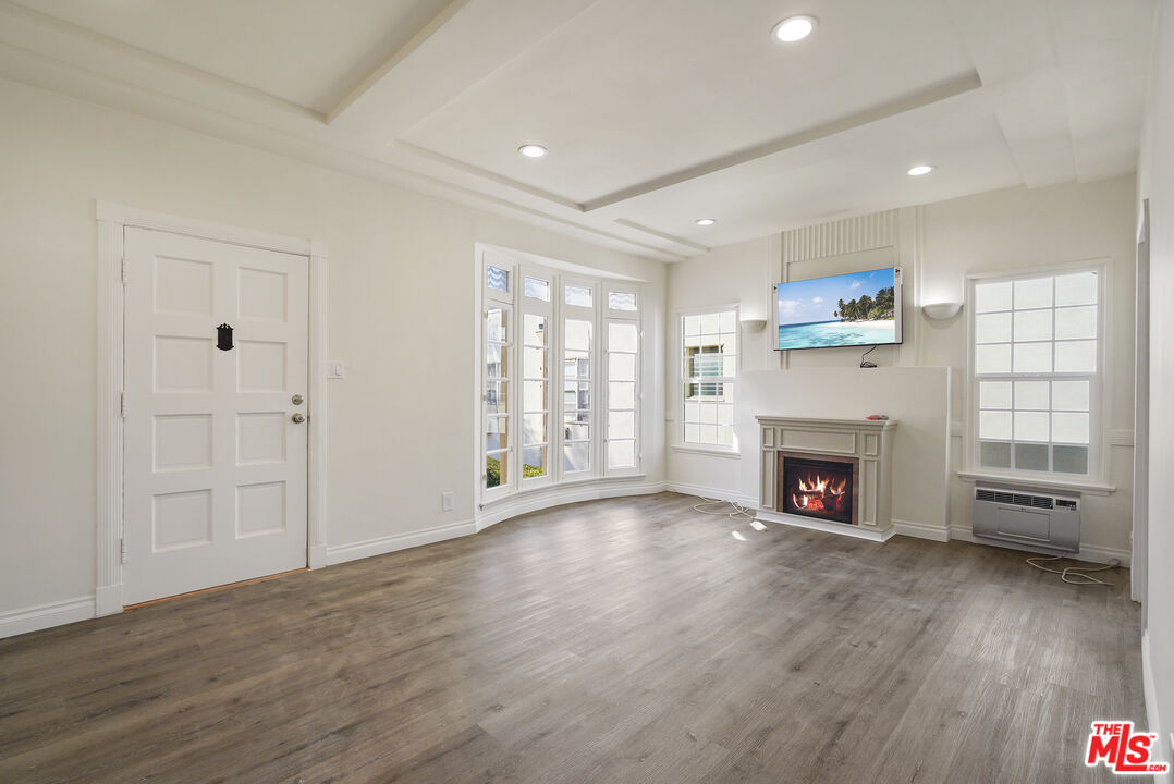 228 South Reeves Drive, Unit D Beverly Hills, CA 90212 - Photo 3 of 13 a view of an empty room with a fireplace and a window