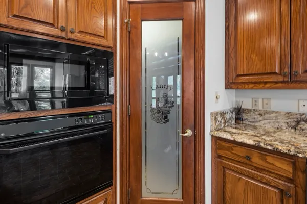 a kitchen with granite countertop cabinets and refrigerator