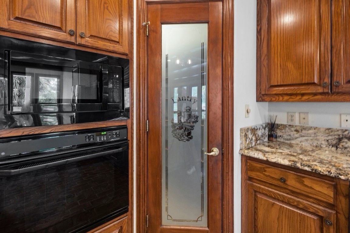 27076 Interstate 10 Winnie, TX 77665 - Photo 11 of 42 a kitchen with granite countertop cabinets and refrigerator