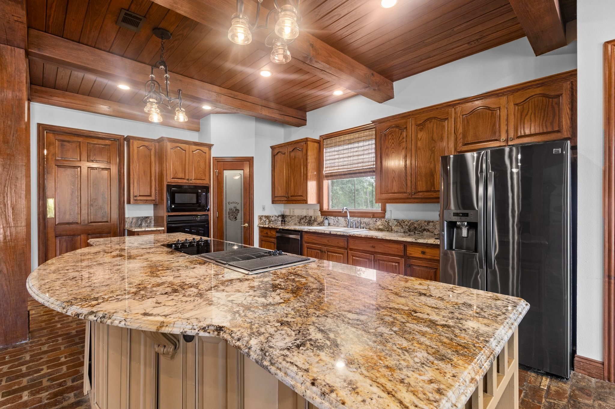 27076 Interstate 10 Winnie, TX 77665 - Photo 14 of 42 a kitchen with stainless steel appliances kitchen island granite countertop a refrigerator and a stove top oven