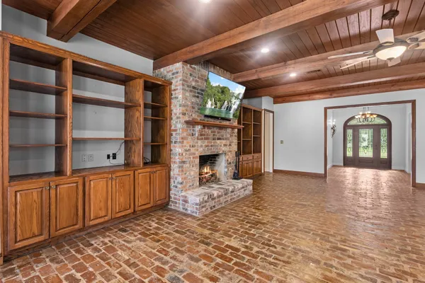 a view of a livingroom with a fireplace and cabinet