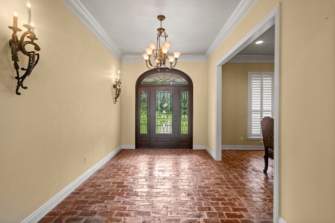 27076 Interstate 10 Winnie, TX 77665 - Photo 2 of 42 a view of a hallway with windows and chandelier