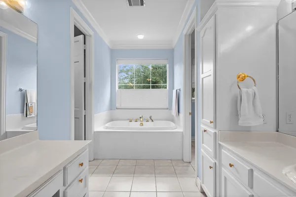 wooden floor with a bed and a painting on the wall