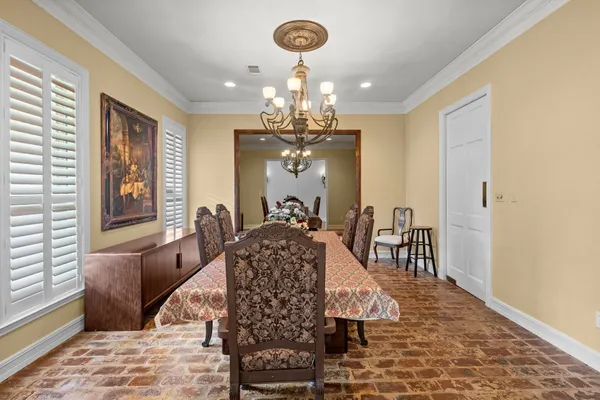 a view of a dining room with furniture and a chandelier