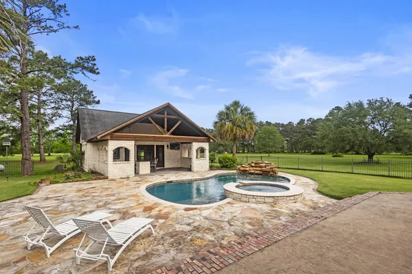 a swimming pool with outdoor seating and yard
