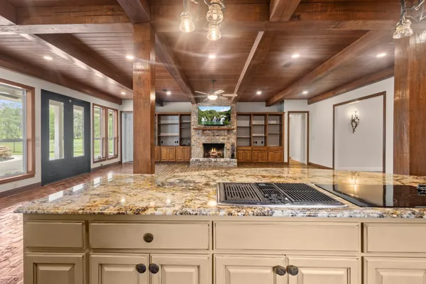 a kitchen with kitchen island granite countertop a stove and a refrigerator