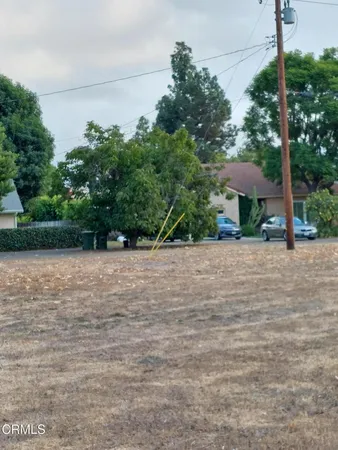 a view of a yard with a table and a chair