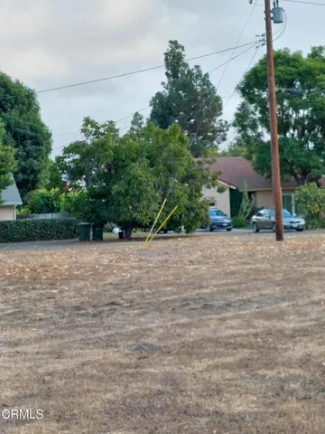 a view of a yard with a table and a chair