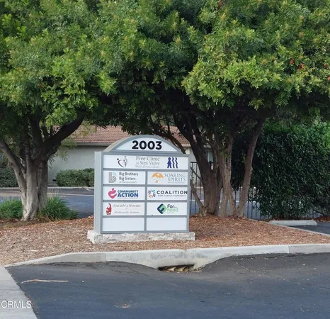 a sign board with a tree