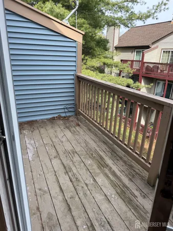 a view of a balcony with wooden floor