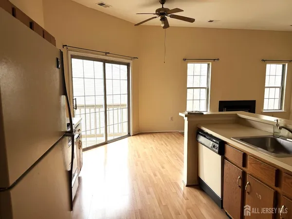 a view of a kitchen with a sink and a window