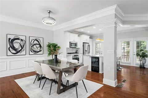 a dining room with furniture and wooden floor
