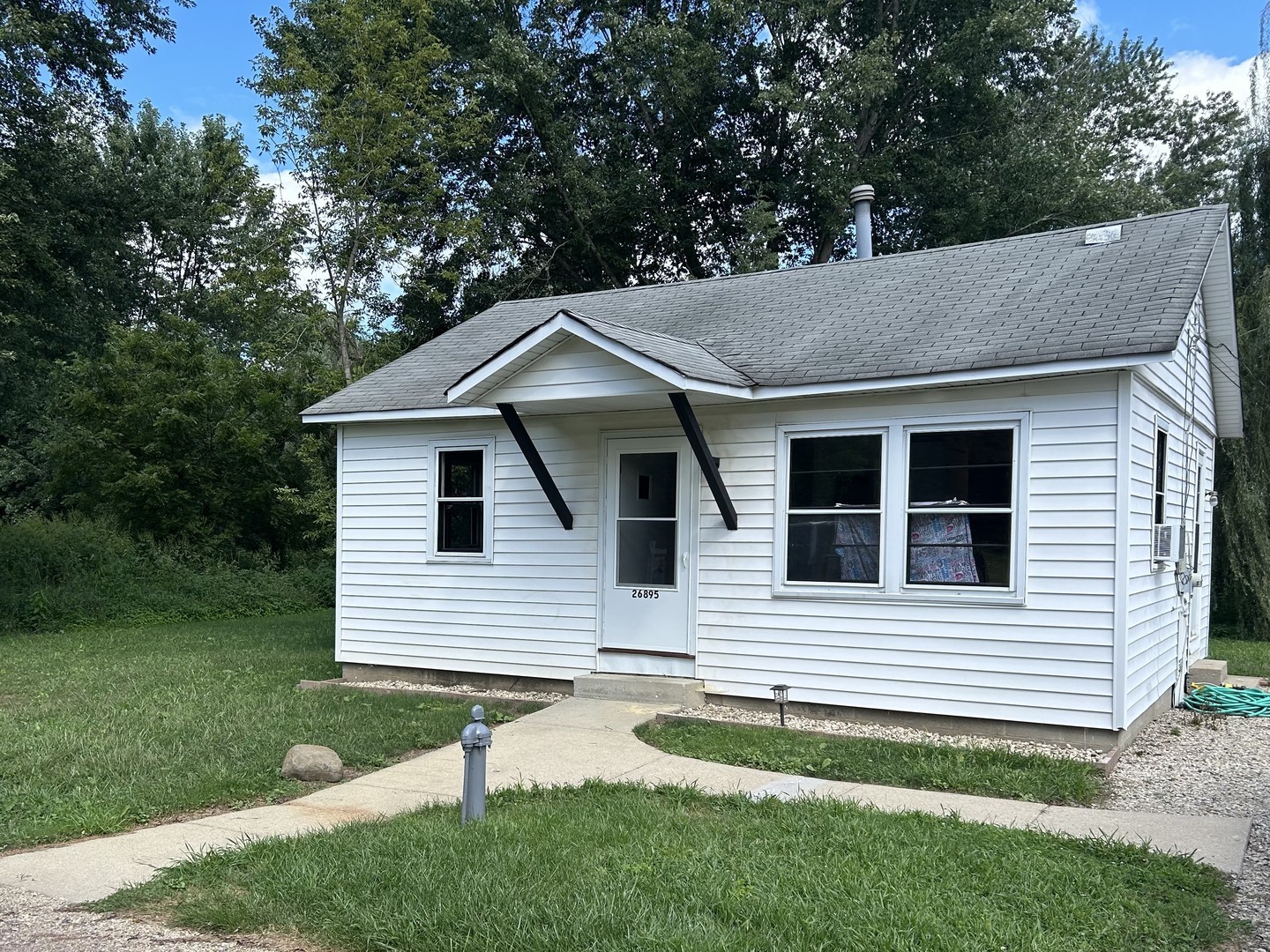 a view of house with a yard