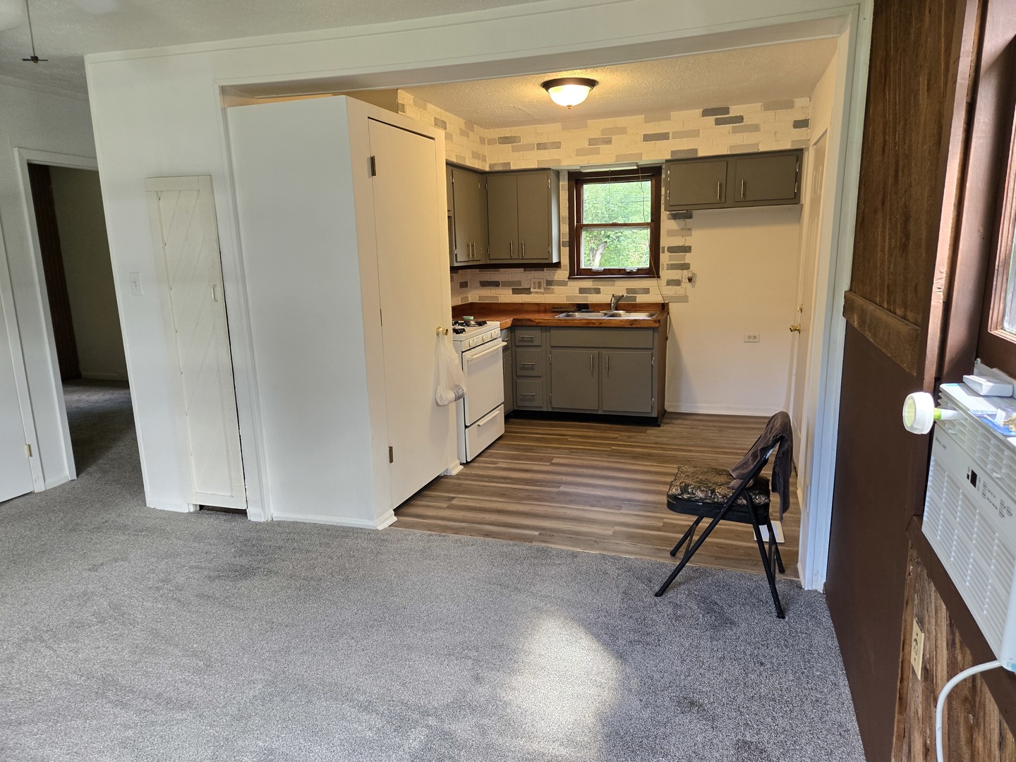 26895 Bernice Street Wauconda, IL 60084 - Photo 4 of 16 a kitchen with a refrigerator and white cabinets